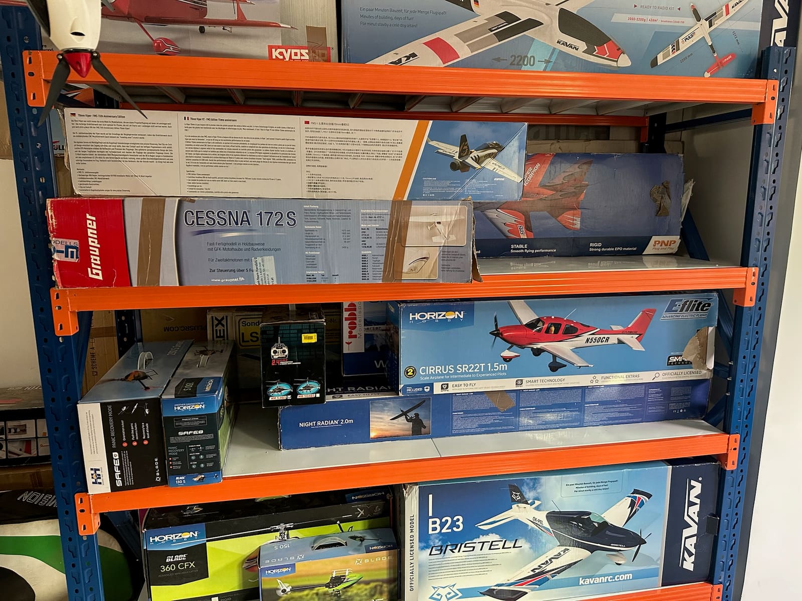 Shelves of RC aircraft kits in the Mekatron workshop