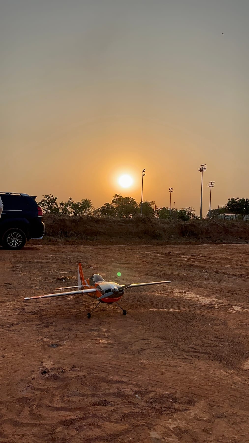 RC aircraft on the field at sunset
